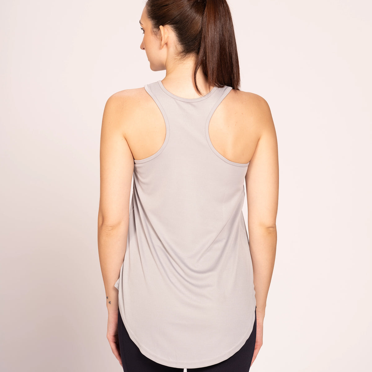 Grey activewear racerback tank top, back view on model showing the racerback — Munns & Mars
