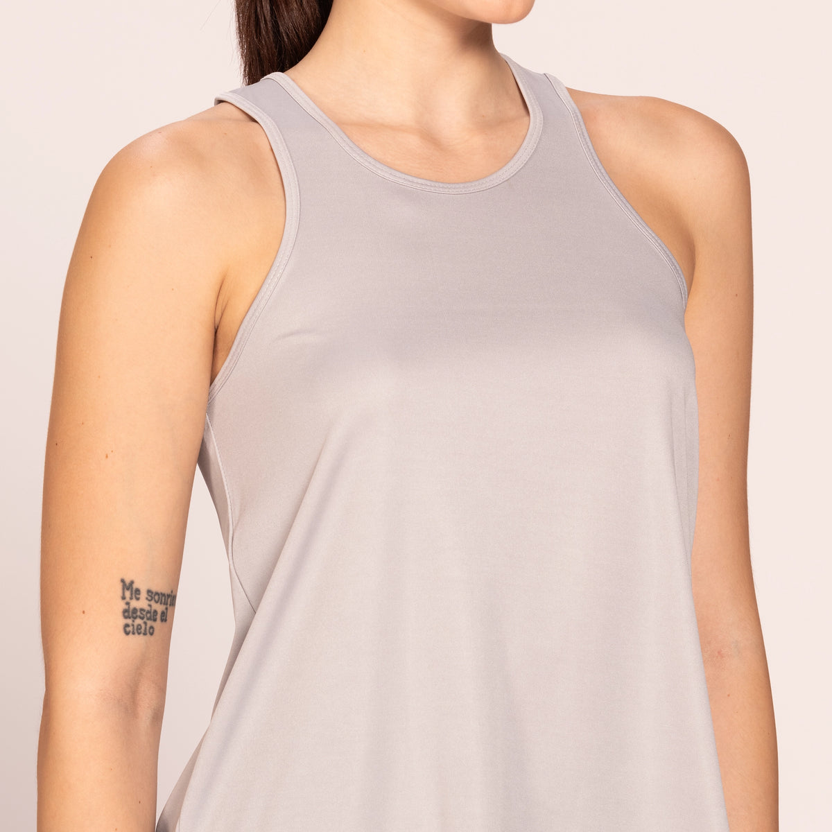 Grey activewear racerback tank top, close-up of the neckline and breathable fabric — Munns & Mars