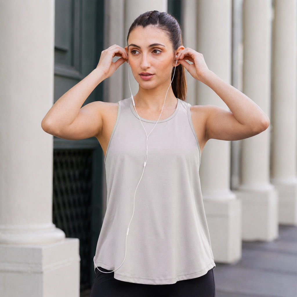 Grey activewear racerback tank top, styled outdoors on model — Munns & Mars