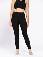 Black ankle-length training tights with pockets, on model — Munns & Mars