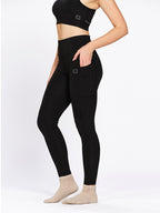 Black ankle-length training tights with pockets, on model — Munns & Mars