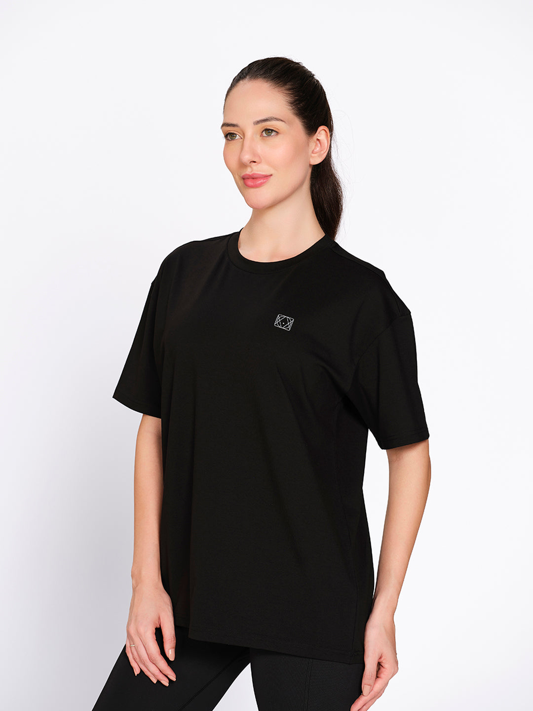 Black oversized hip-length cotton-spandex t-shirt, on model — Munns & Mars