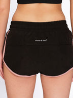Black dry-fit running shorts with inner panty, on model — Munns & Mars