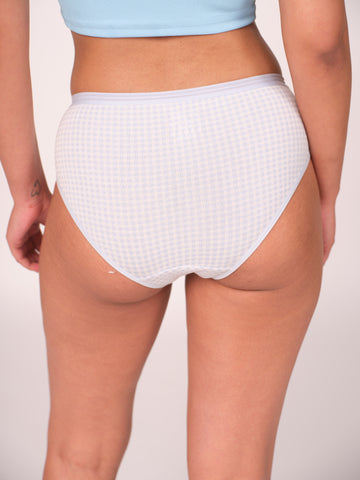 White waffle-textured underwear worn by a person on a plain background
