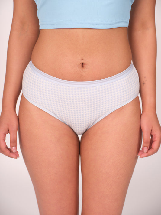 Person wearing white waffle-textured underwear on a plain background
